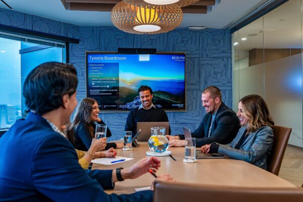 Team meeting in the Tysons boardroom at Carr Workplaces
