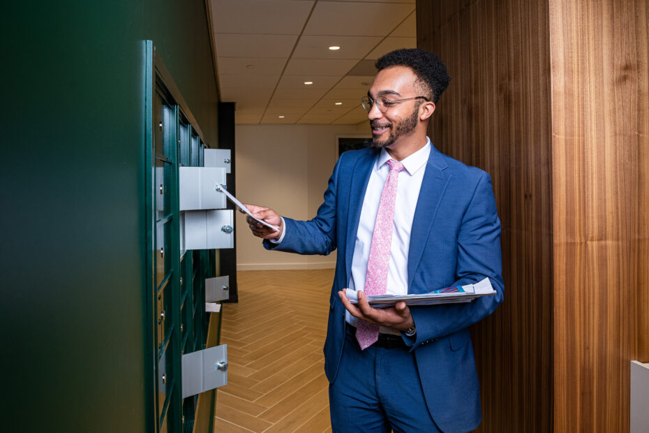 Professional collecting mail at Carr Workplaces Friendship Heights