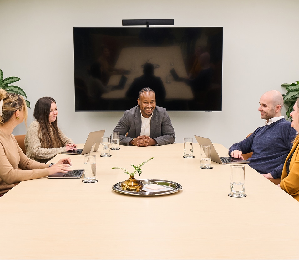 Team collaborating around a conference table in a Carr Workplaces meeting room