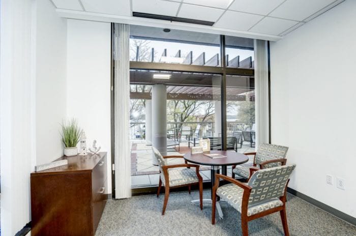 Lounge Area at Old Town office space of Carr Workplaces with a large glass window looking directly onto the patio.